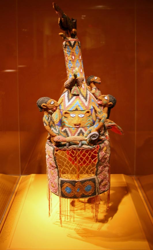 Crown, Yoruba peoples, Ekiti region, Ikere, Nigeria. “A beaded crown with veil is the defining symbol of divine kingship among the Yoruba and holds the combined powers of the living king and the ancestors. The crown's material, form, pattern and color all proclaim the king's sacred power and authority. The frontal face represents Oduduwa, the divine founder and first king of Ile-Ife, the sacred first city of the Yoruba.” 