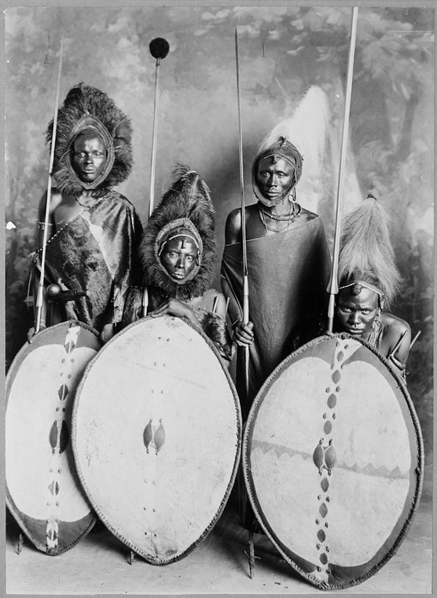 Four Maasai warriors in full war dress, Kenya. 