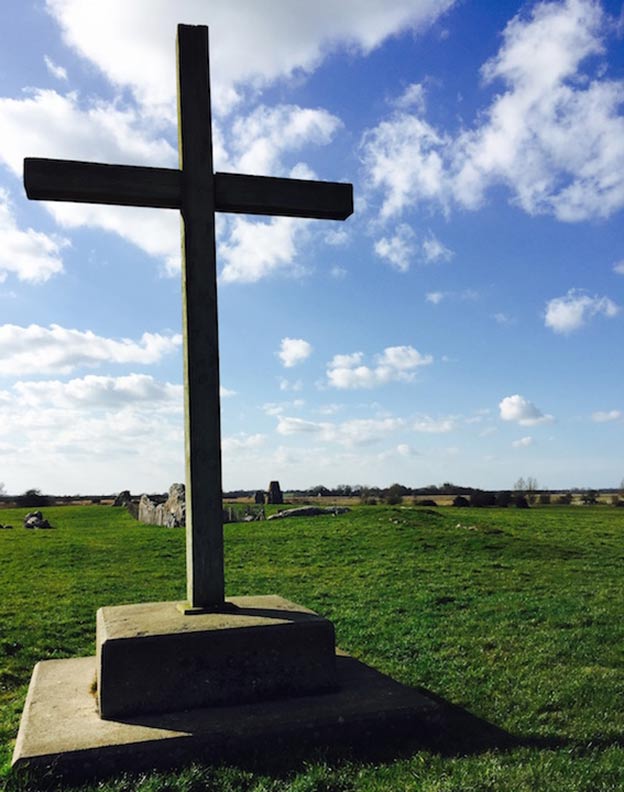 Wooden cross marks the original site of the abbey’s high altar, with the gatehouse in the far distance. 