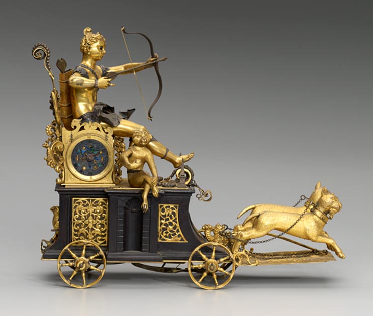 An automaton chariot clock of the Renaissance. South Germany, c. 1610. “Diana has moving eyes connected to the clockwork and when a mechanism inside the case is wound up the chariot rolls forward, the two leopards leap, the bird comes forward, and the monkey eats the apple. If all these elements are set in motion the goddess shoots her arrow.” 