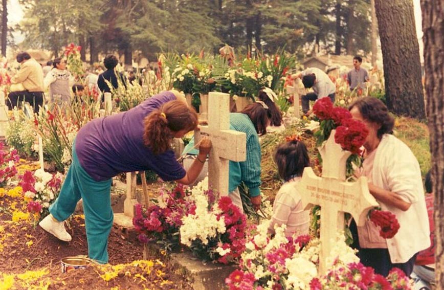 Tidying and decorating graves for Día de los Muertos, Almoloya del Rio, Mexico.